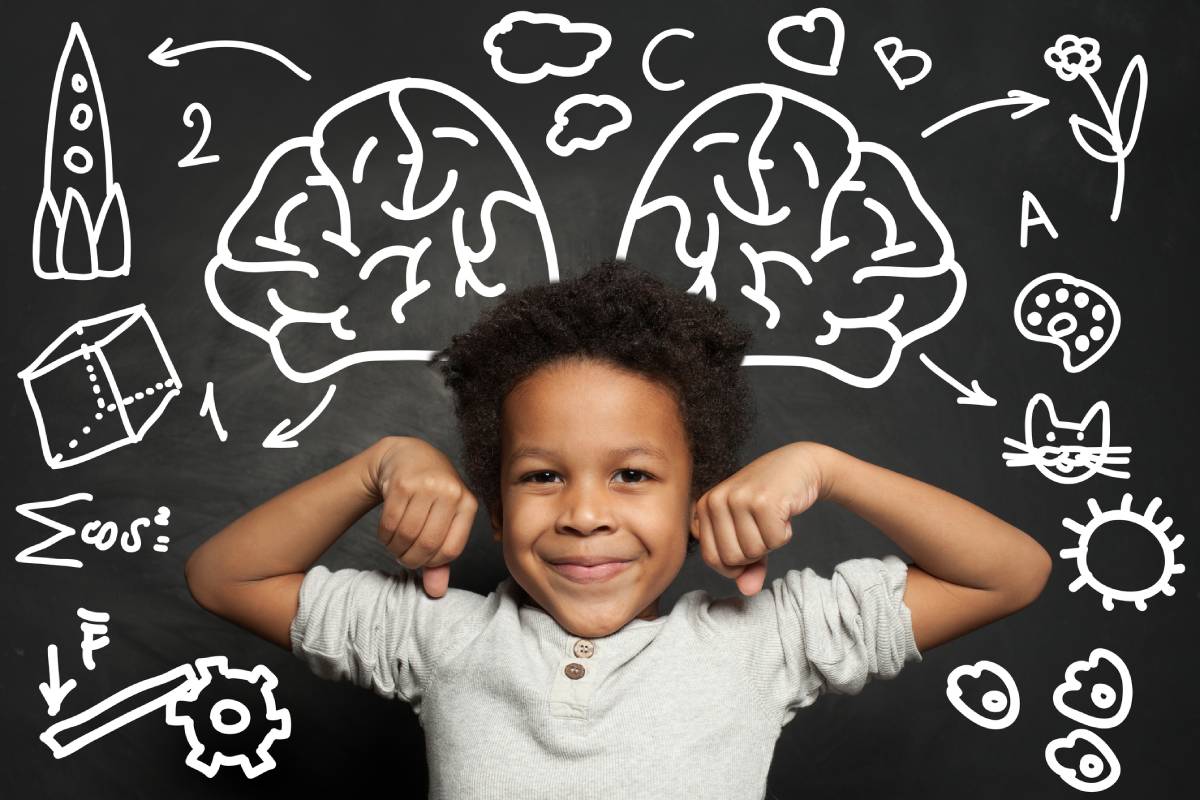 Happy successful clever child boy on chalkboard background, brainstorming and left and right cerebral hemisphere.